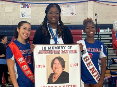 Photo of two Christiana HS students and admin presenting memorial banner in memory of Jennifer Mayer